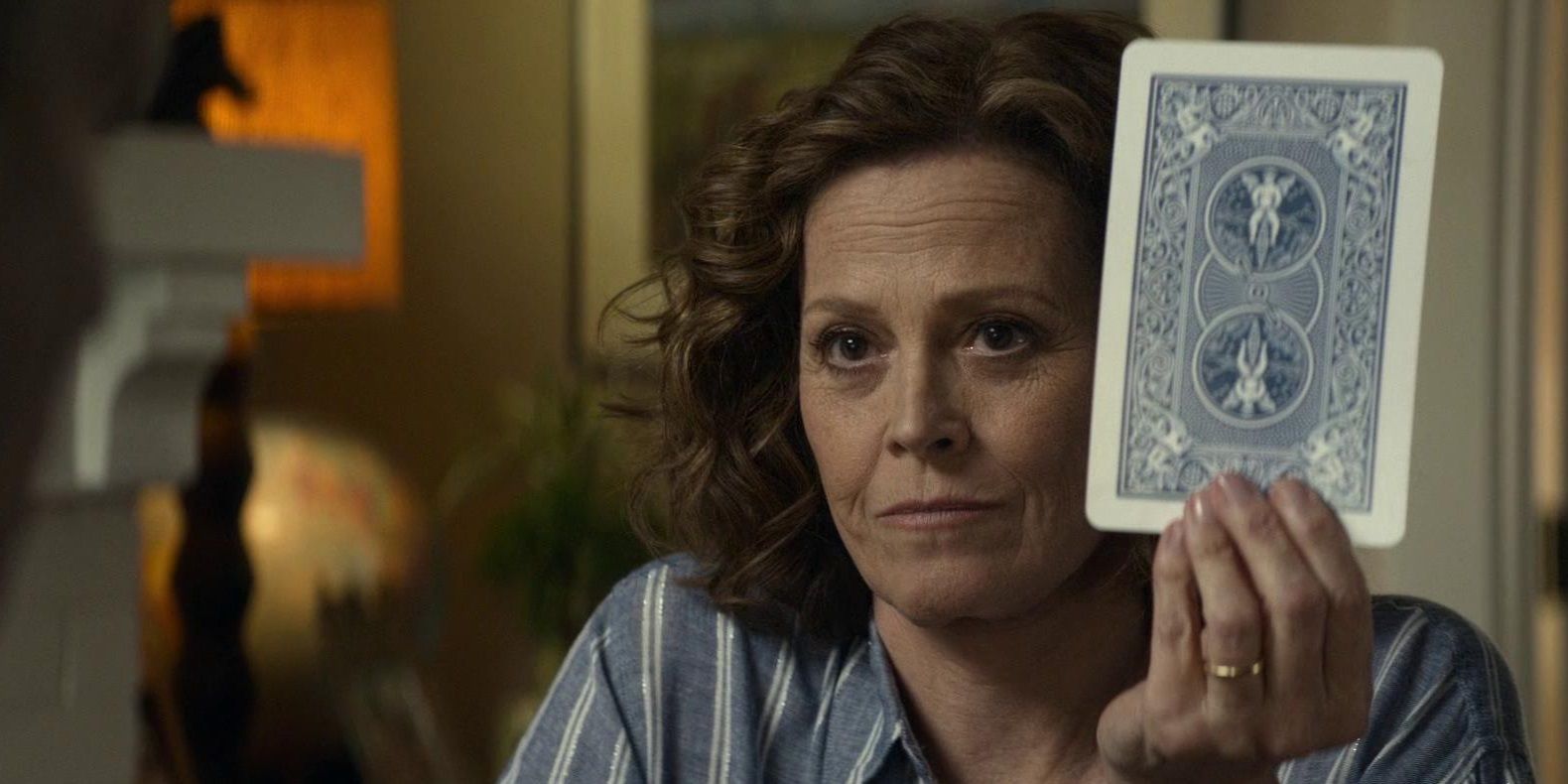Sigourney Weaver with a tarot card in Ghostbusters Afterlife