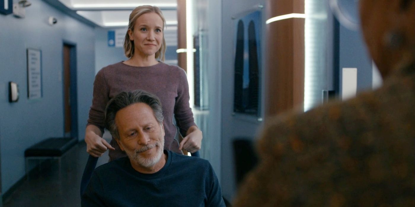 Steven Weber as Dr. Dean Archer being pushed by Jessy Schram as Dr. Hannah Asher in Chicago Med Season 9.