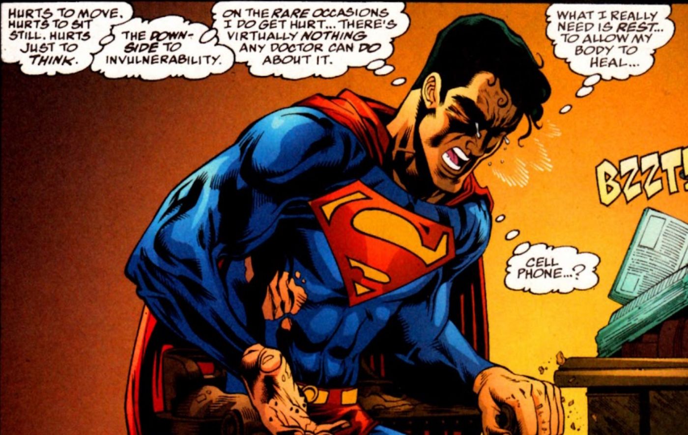 Comic book panel: Superman grimaces in pain.