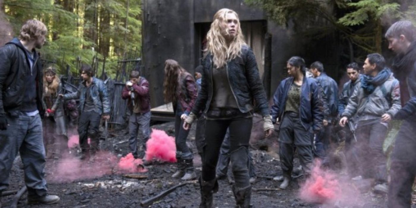 Clarke Griffin and the other members of The 100 standing on the battlefield in the season 1 finale