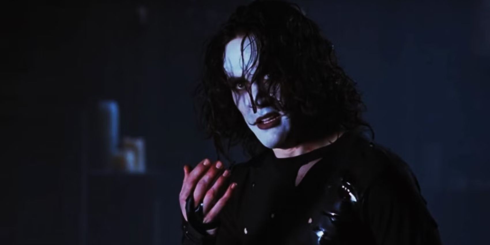 Brandon Lee holding his hand as the titular character in The Crow 1994