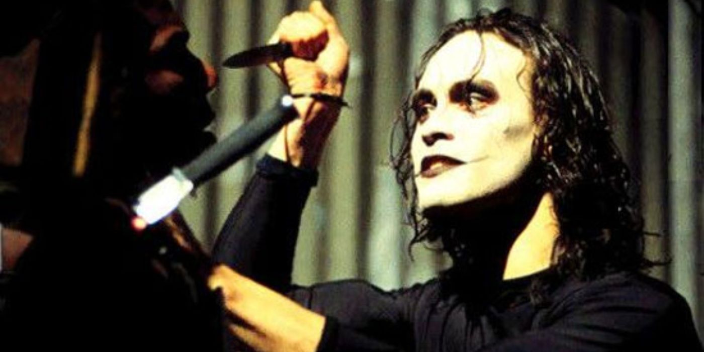 Brandon Lee as The Crow intimidates a criminal in The Crow (1994).
