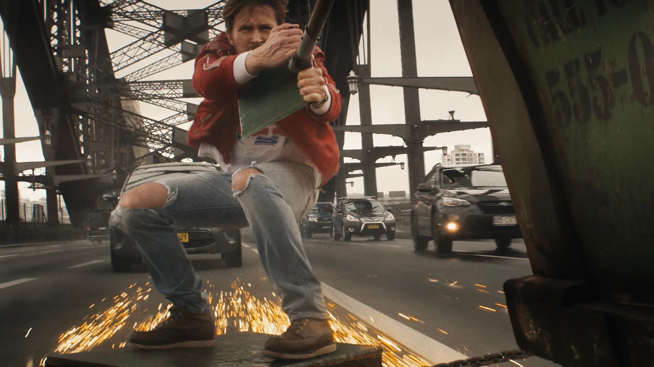Colt Seavers (Ryan Gosling) surfing across a bridge on a piece of metal in The Fall Guy trailer