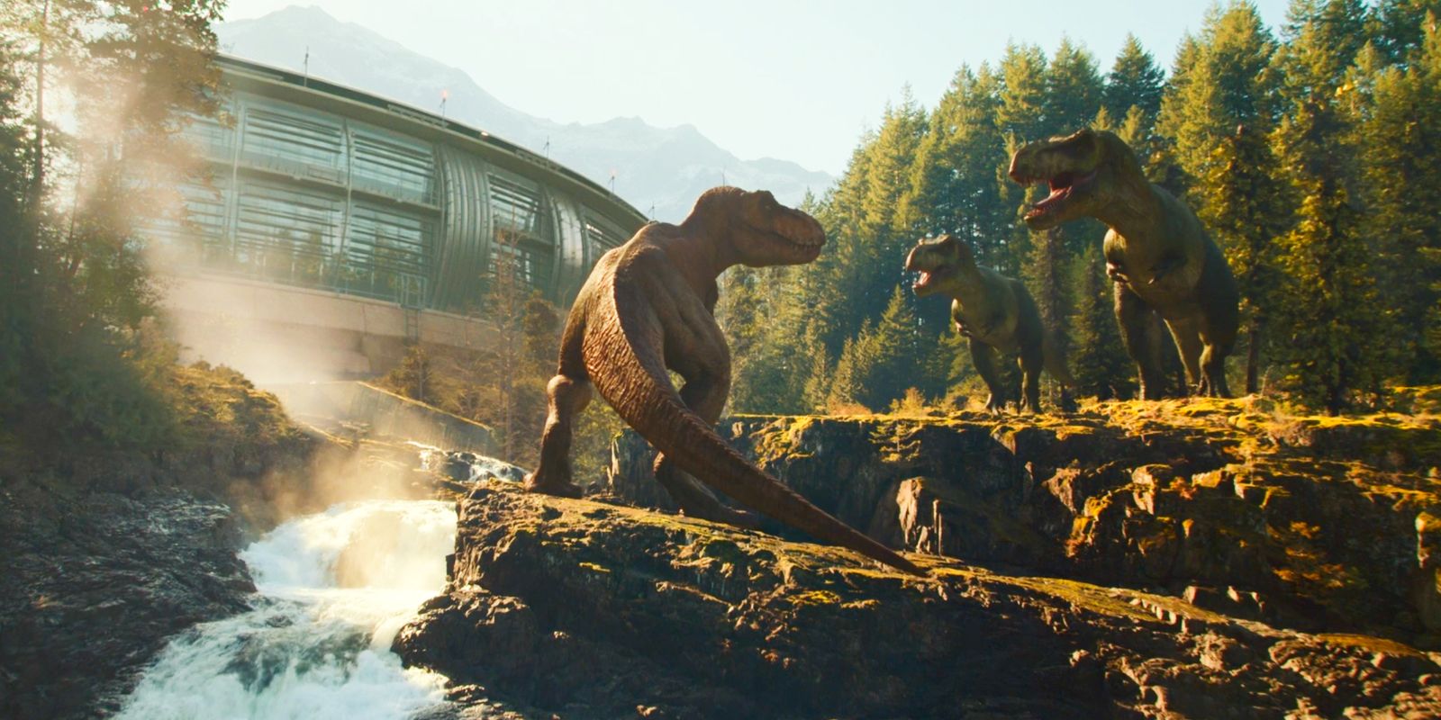 Three T-rexes standing on top of cliffs in Jurassic World Dominion