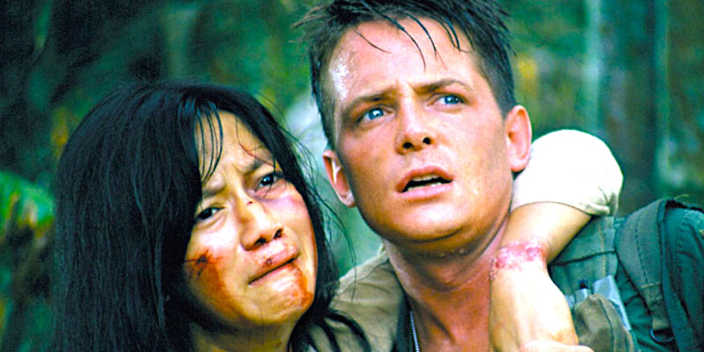 Thuy Thu Le bloodied with her arm around a desperate looking Michael J. Fox in a dramatic scene from Casualties of War