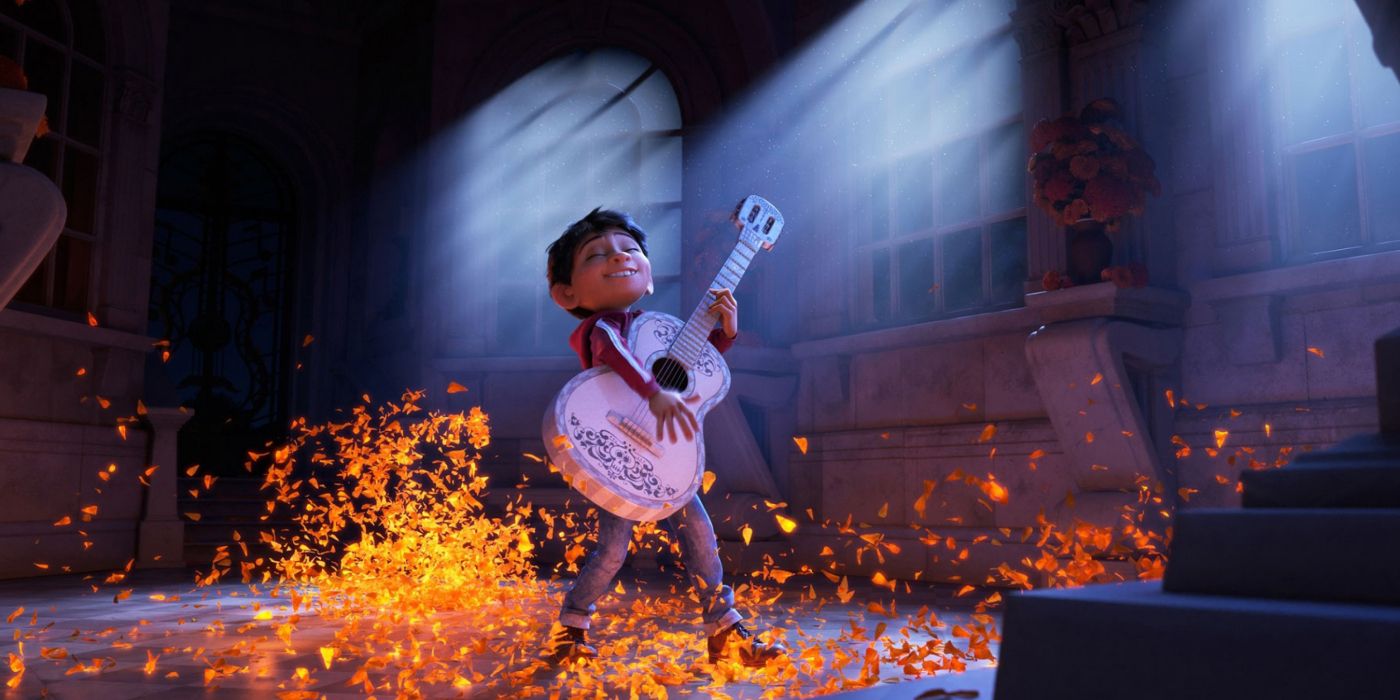 Miguel playing his guitar and surrounded by a glowing orange light in Disney's Coco