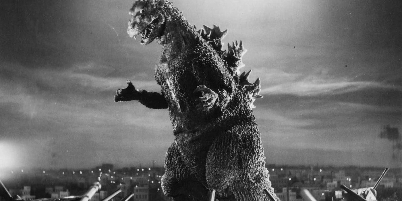 The Godzilla creature looking over a town in Godzilla, King Of Monsters