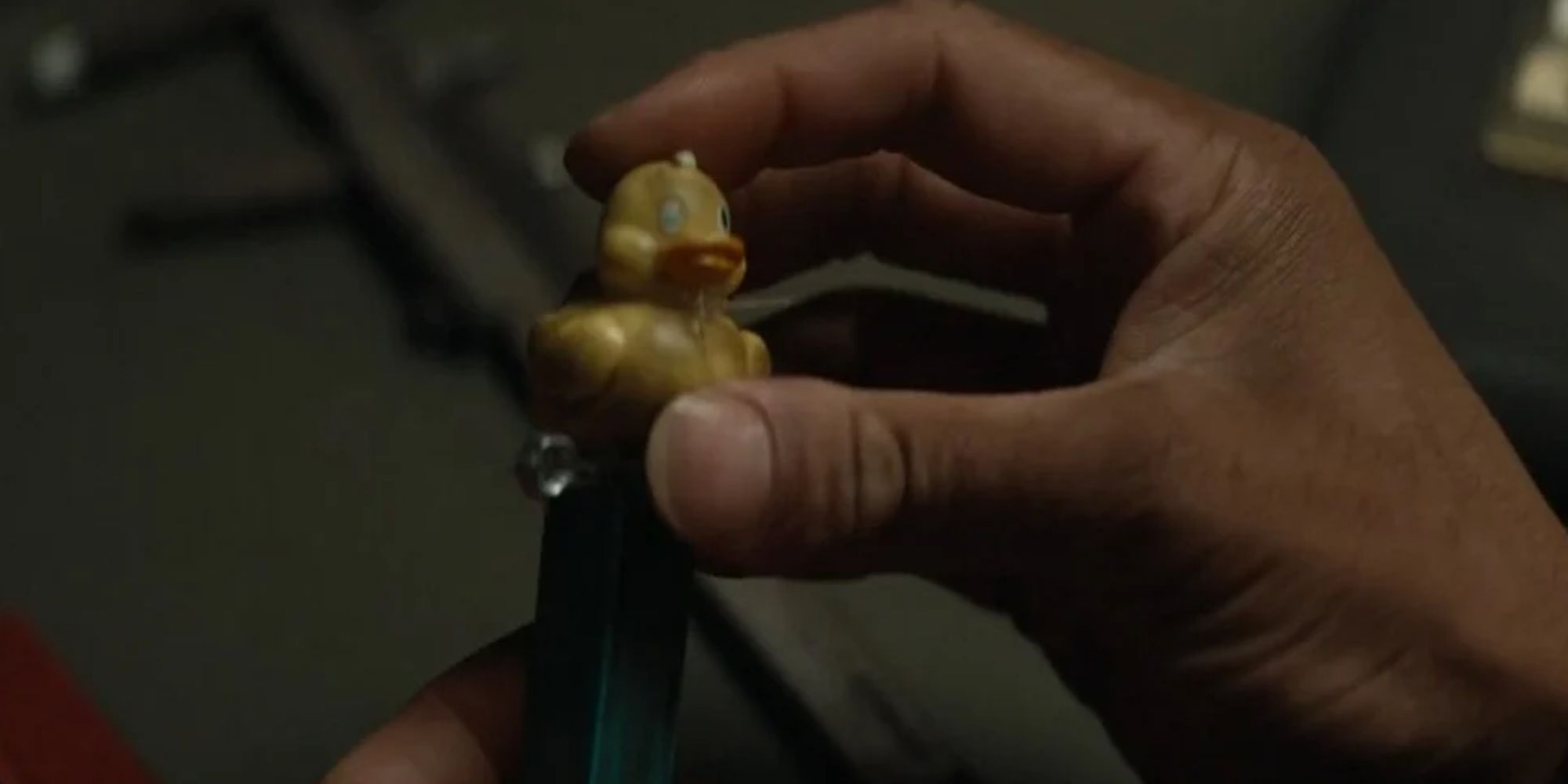 Hands holding a relic known as a Duck Pez dispenser in Silo