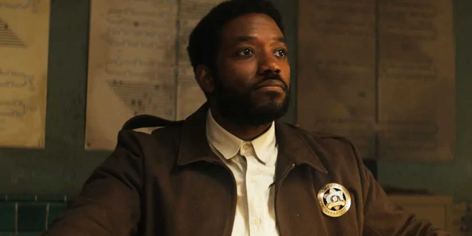 Chinaza Uche as Paul Billings looking stern in Silo