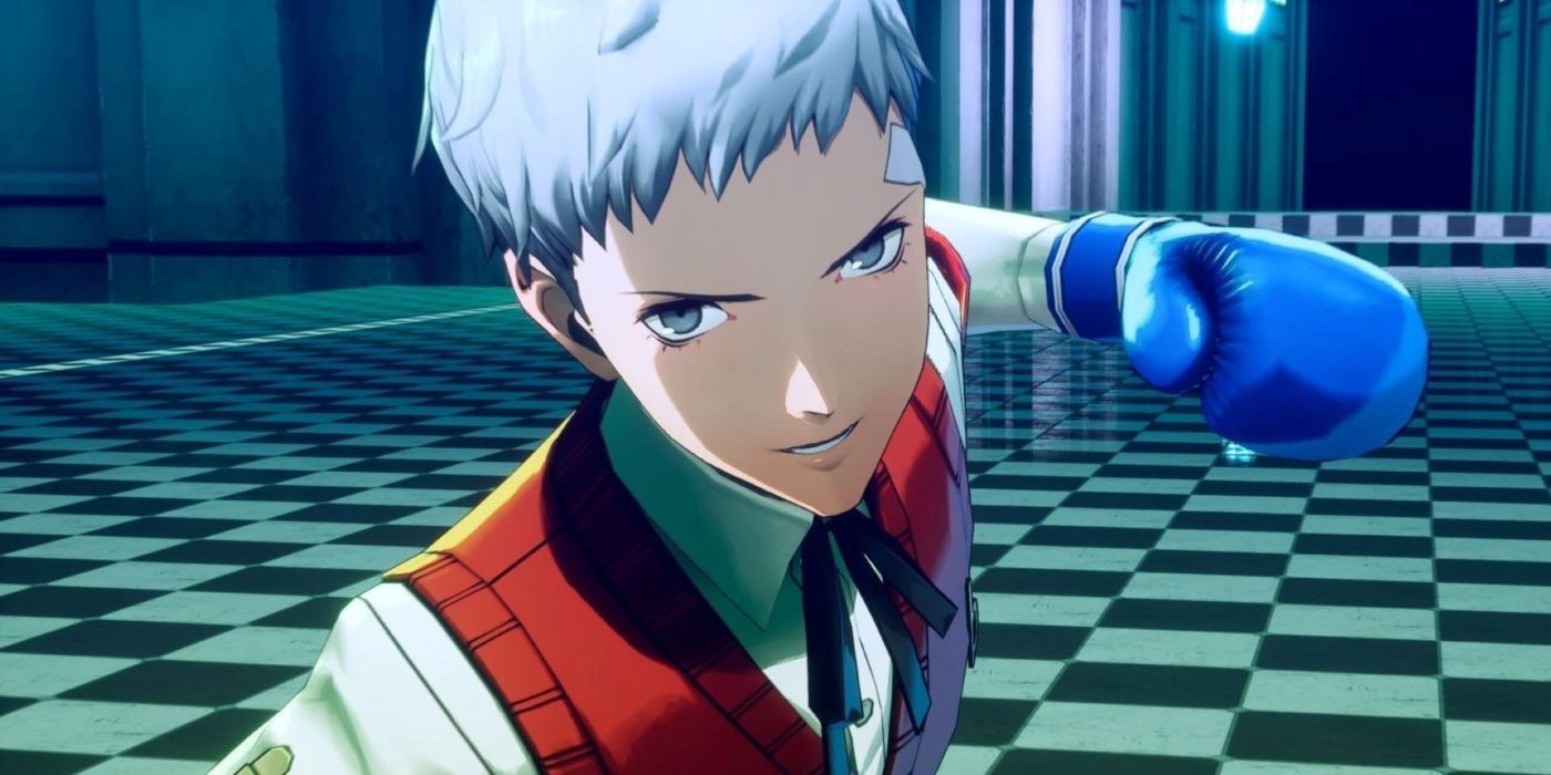 Akihiko Sanada with a blue boxing glove winding up to punch an unknown target while he grins in anticipation in Persona 3 Reload