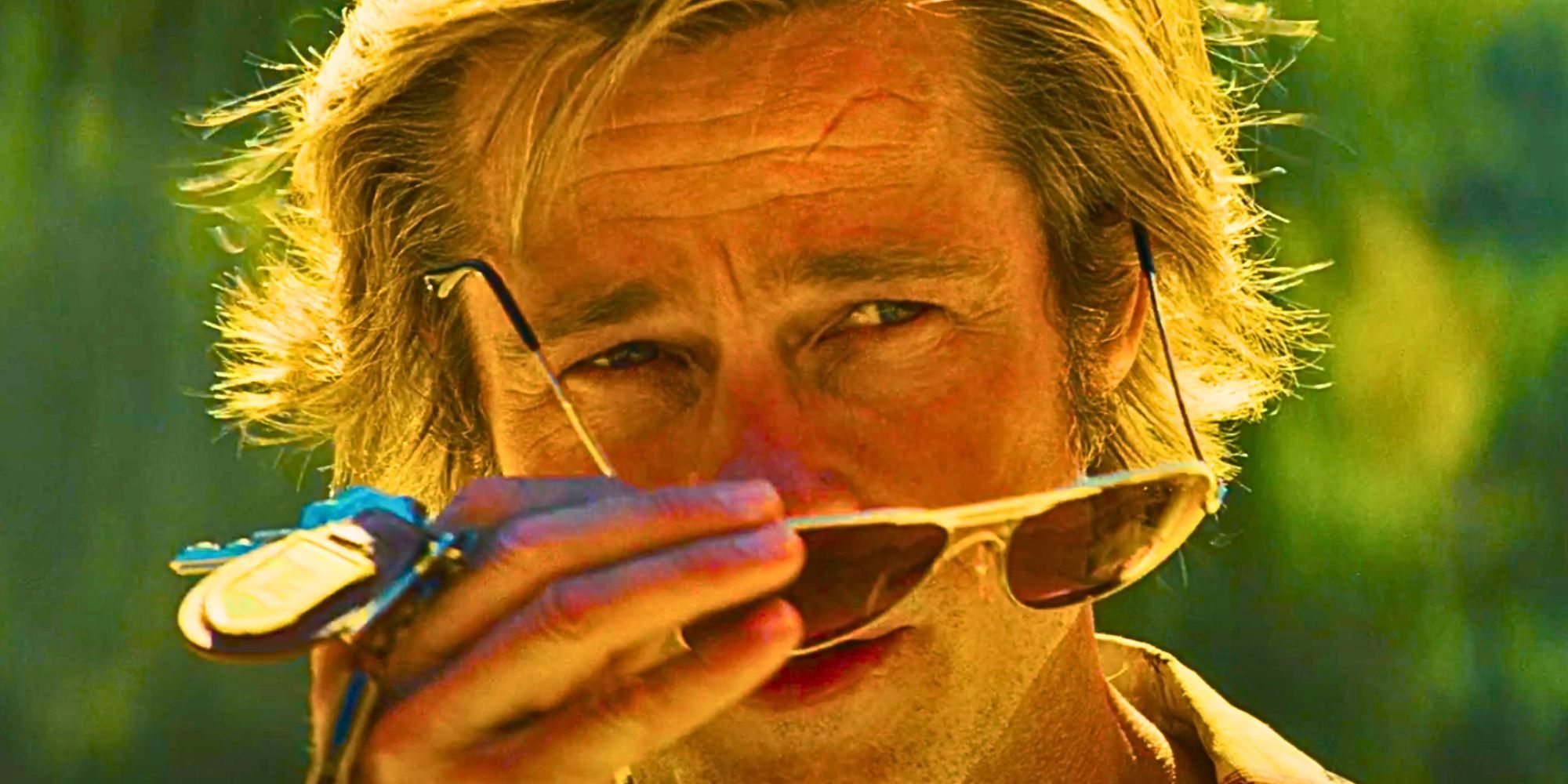 Brad Pitt as Cliff booth removing his sunglasses in Once Upon a Time in Hollywood