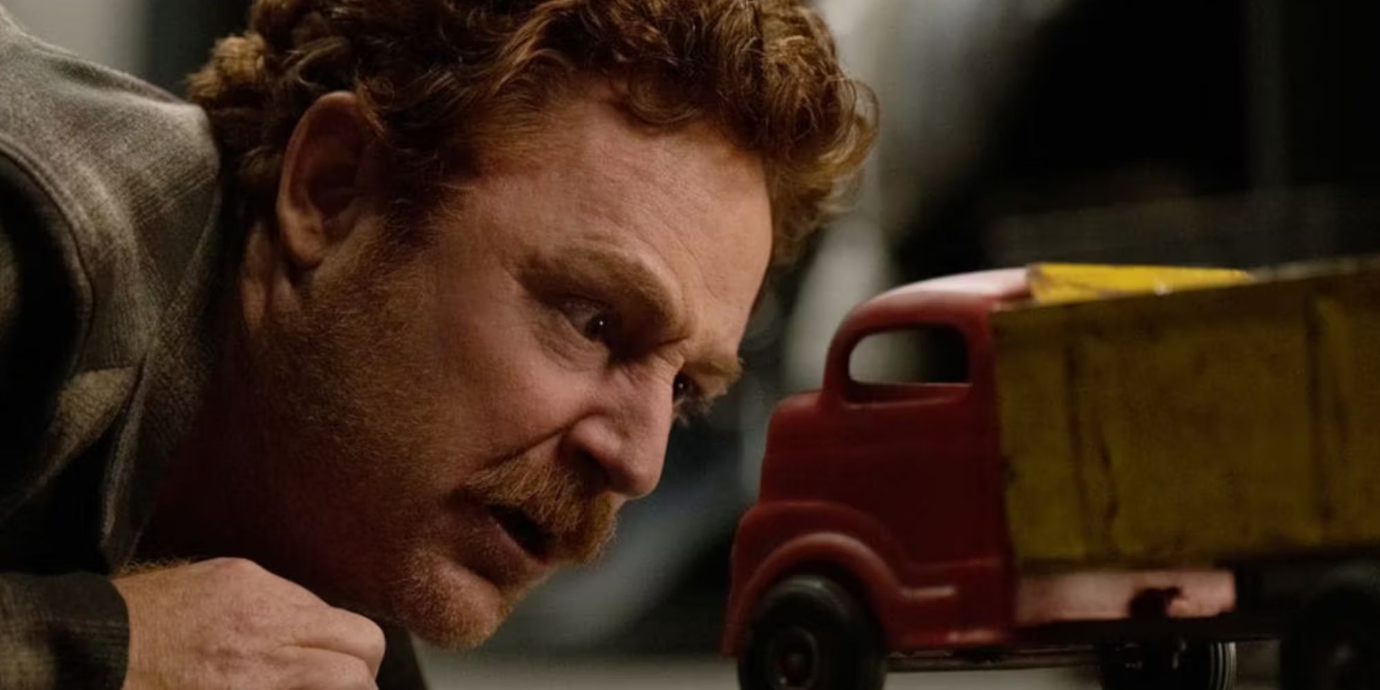 Scott Grimes as Matty Bennett looking confused at Dennis the truck