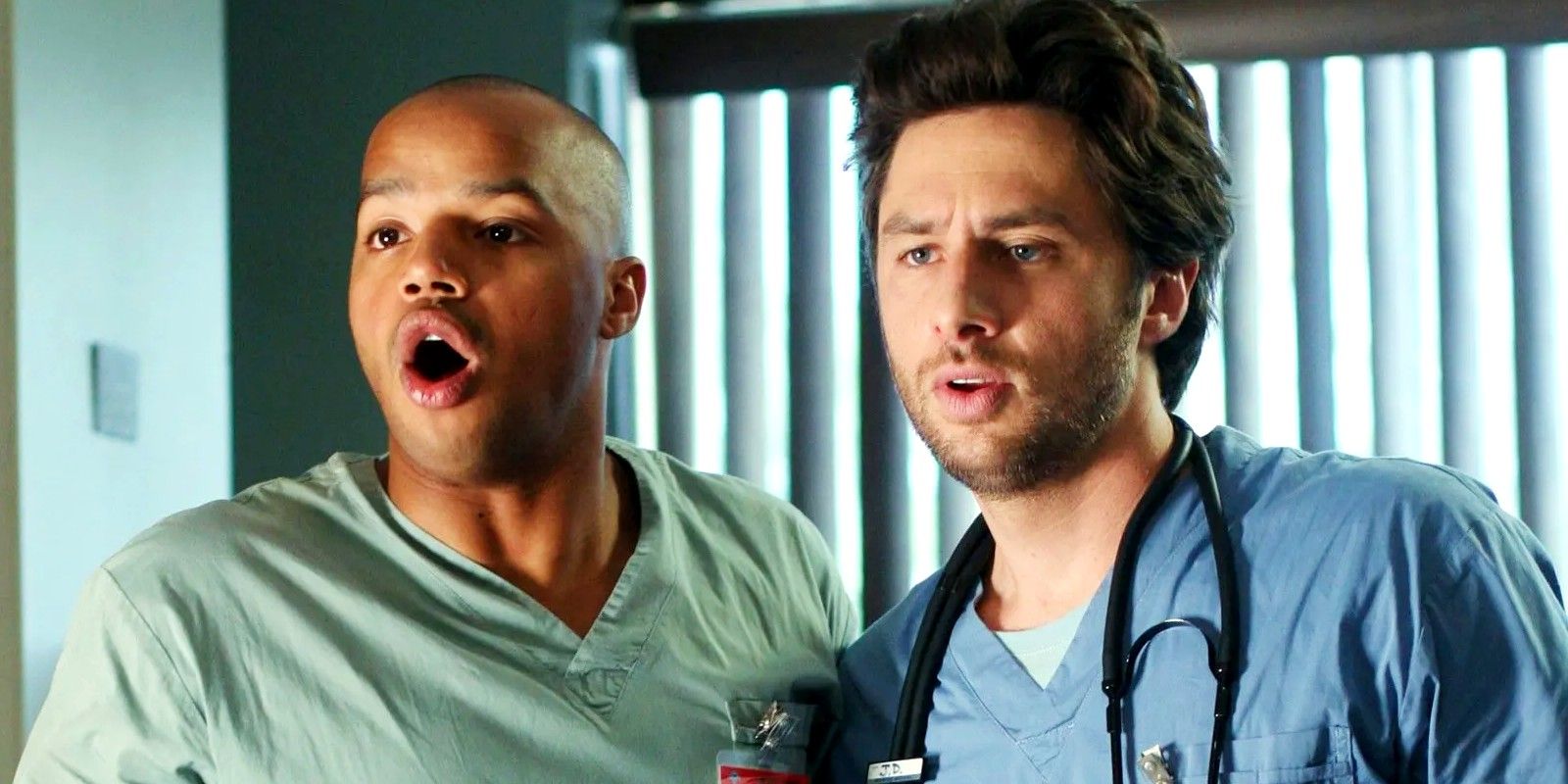 Zach Braff and Donald Faison looking at something in Scrubs