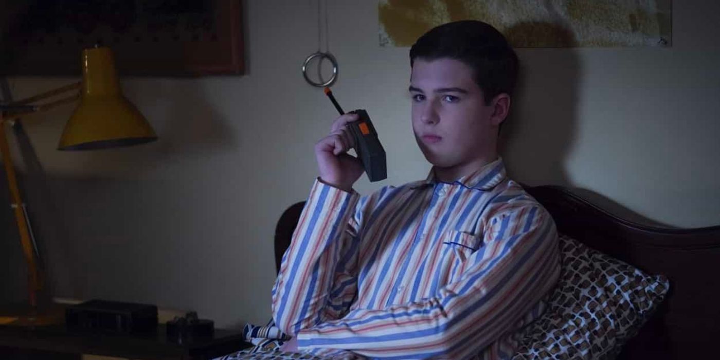 Sheldon looks unamused while talking into his walkie talkie in bed in Young Sheldon season 6