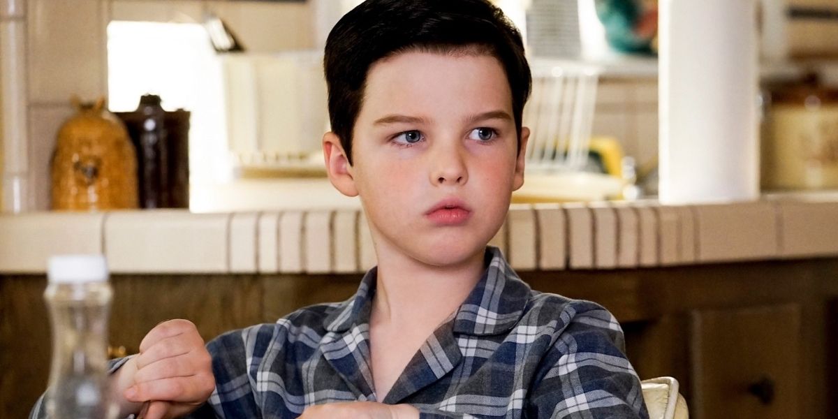 Sheldon looking surprised at the table in Young Sheldon