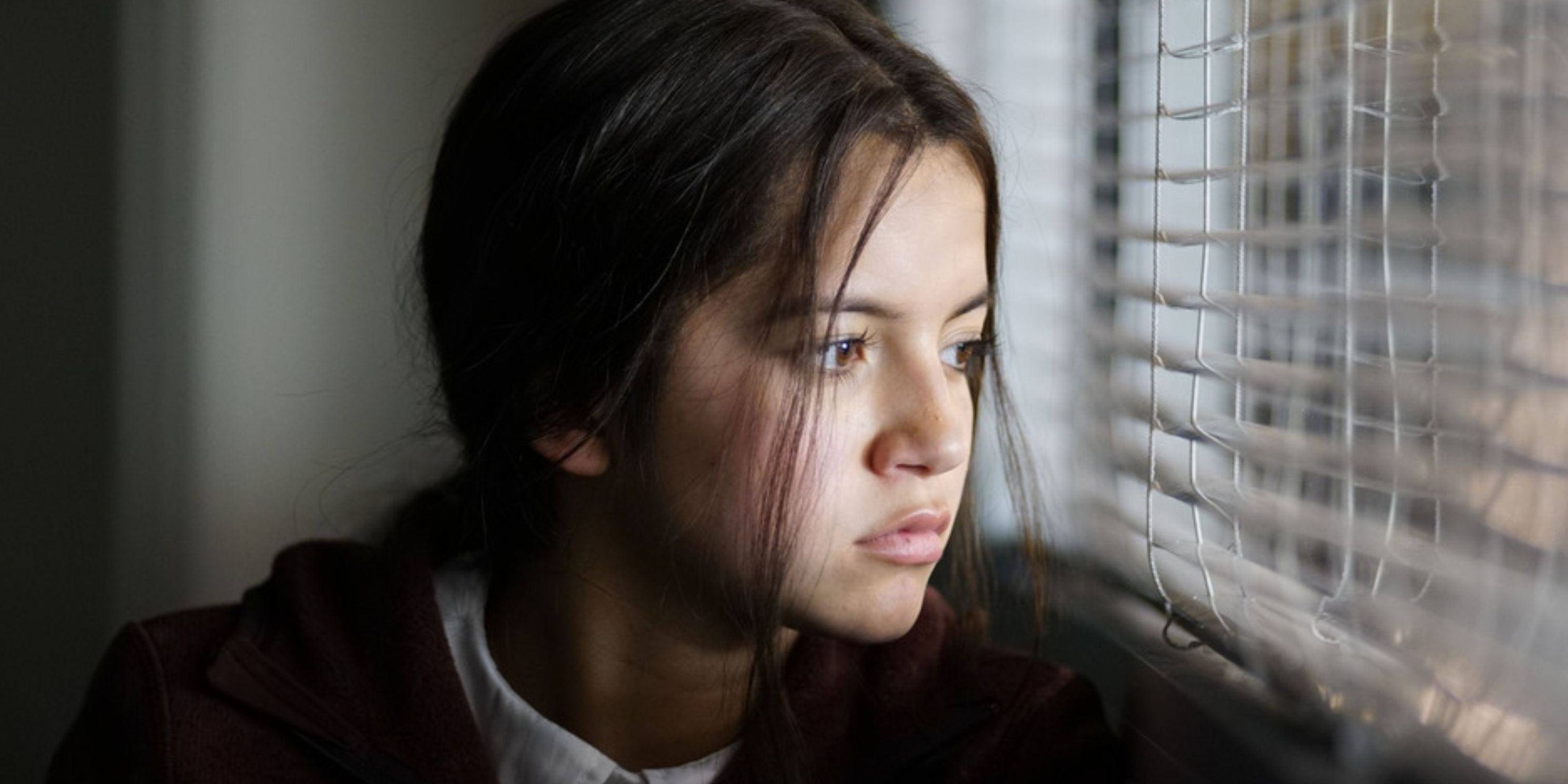 Isabela Merced looking out a window in Sicario 2 