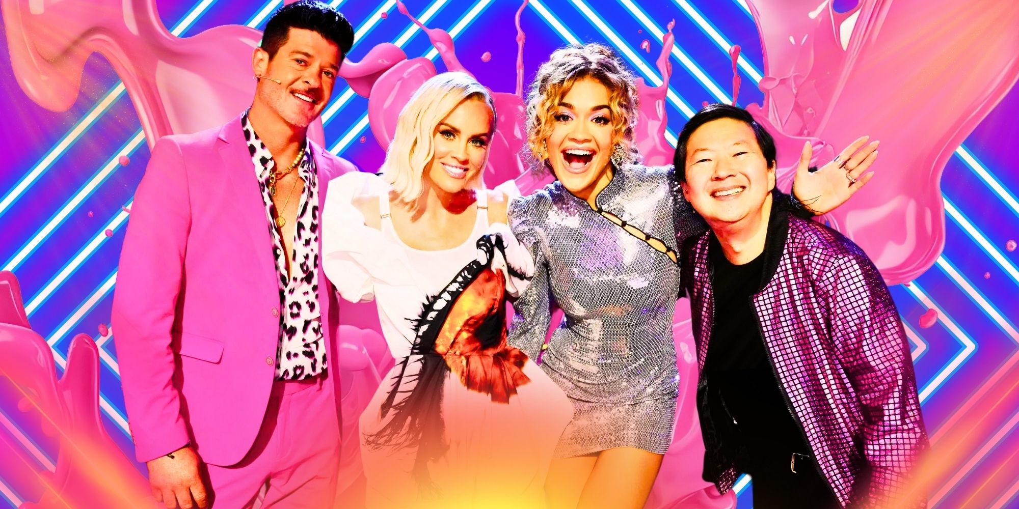 The Masked Singer Season 11 cast of panelists Robin Thicke, Jenny McCarthy, Rita Ora and Ken Jeong smile, with pink paint splashing behind them