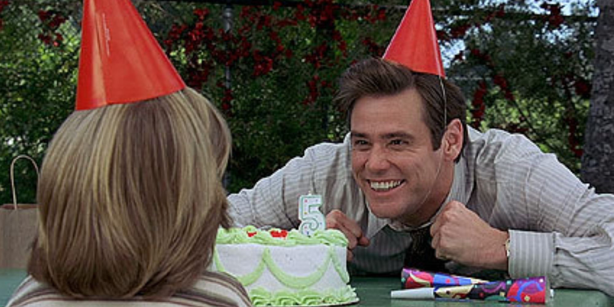 Jim Carrey as Fletcher Reede in Liar Liar smiling by Max's birthday cake