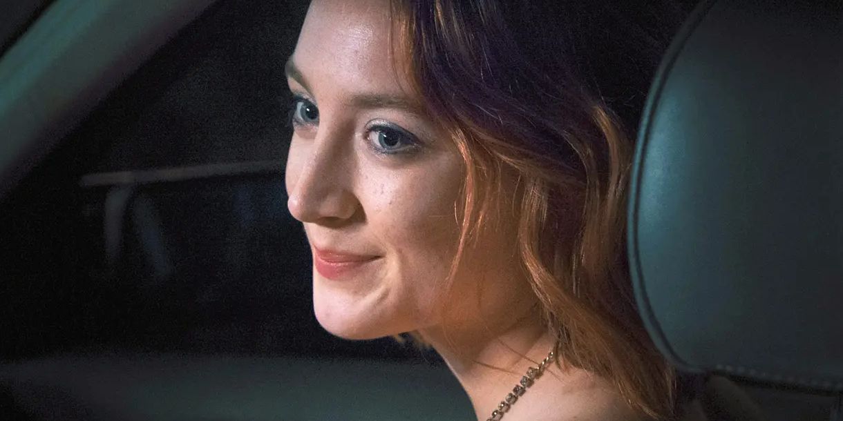 Saoirse Ronan as Lady Bird smiling in a car on the way to prom