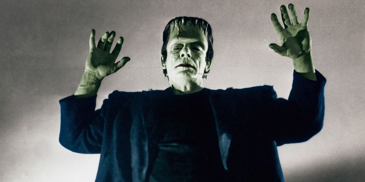 Glenn Strange as Frankenstein posing with his arms raised