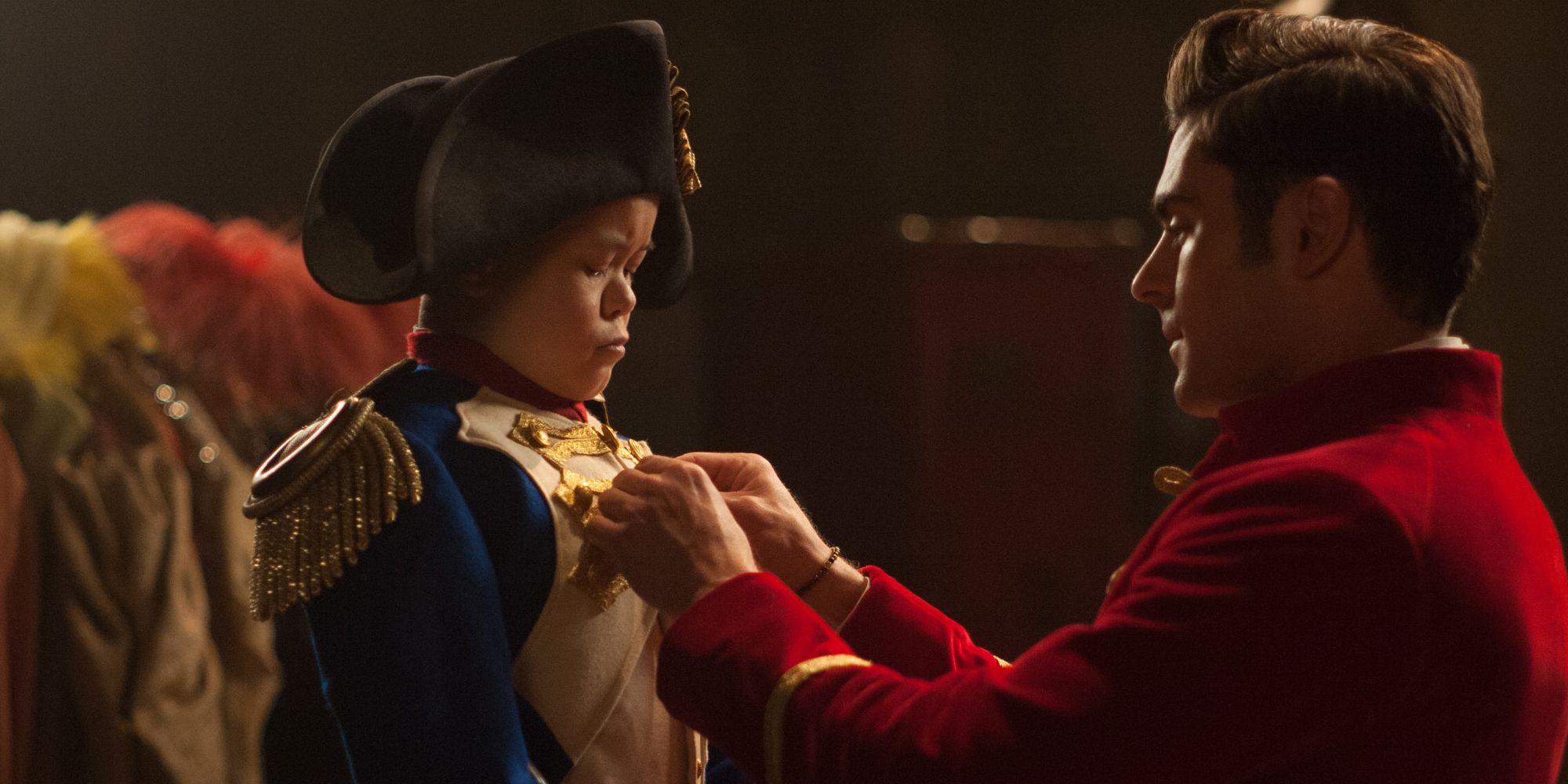 Hugh Jackman as PT Barum helping to dress Sam Humphrey as Charles Stratton aka General Tom Thumb in The Greatest Showman