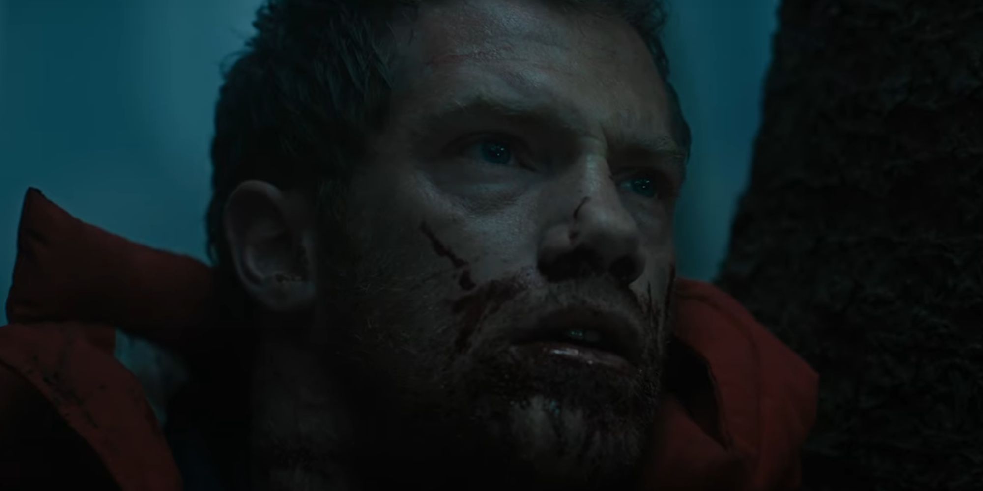 Alistair Brammer looking bloodied and afraid as John in The Watchers trailer
