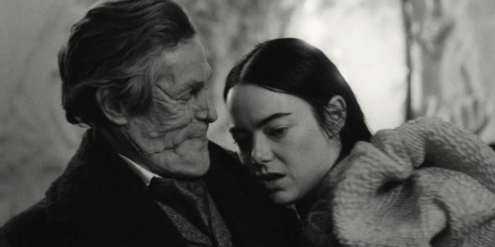 Emma Stone as Bella Baxter in Poor Things being held by Willem DaFoe's Godwin McCandles
