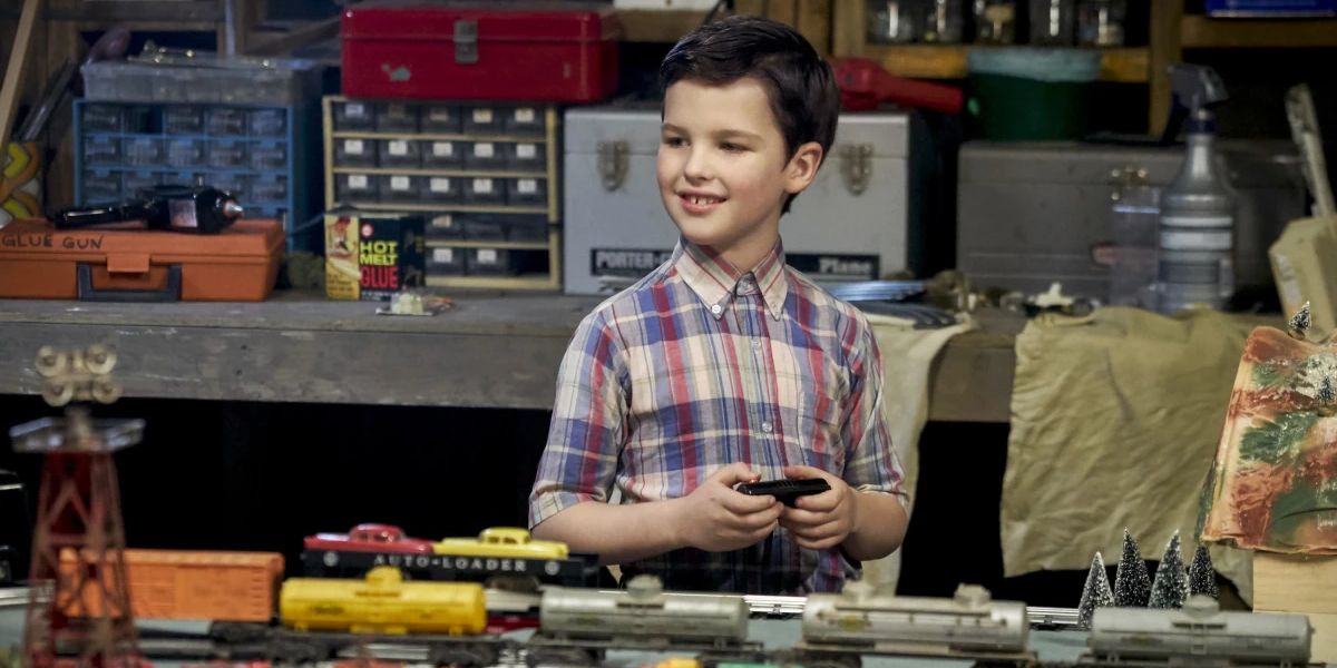 Sheldon smiling with a train set in Young Sheldon