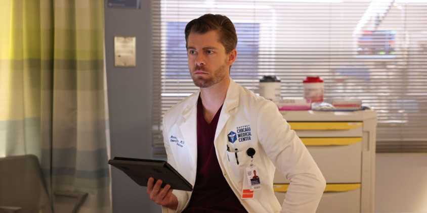 Ripley holding a tablet and looking at test results in a hospital room in Chicago Med.