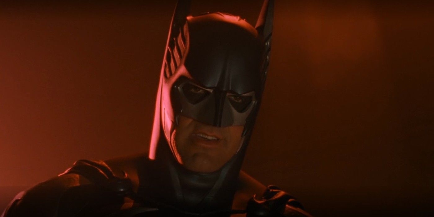 A close-up of George Clooney as Bruce Wayne in front of red smoke in Batman & Robin (1997)