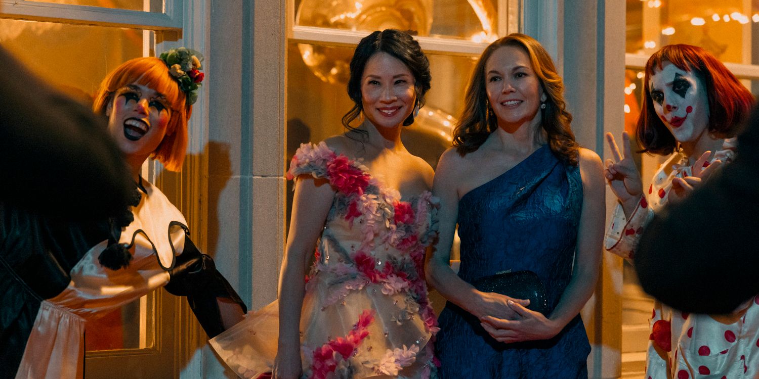 Lucy Liu and Diane Lane as Martha and Joyce posing for a picture next to two clowns in A Man in Full