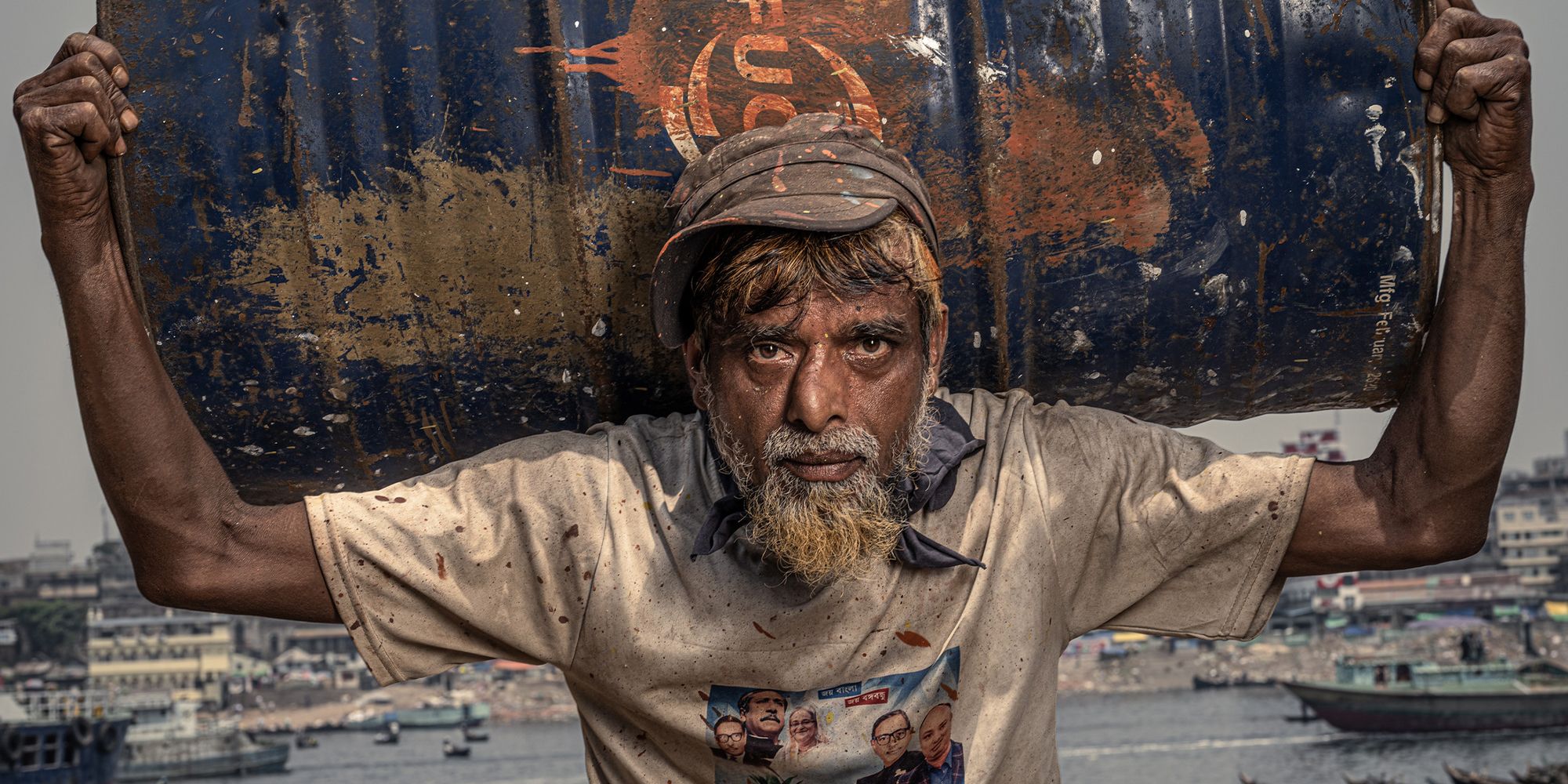 A shipyard worker holds a barrel over his head at the Dhaka ship-repair yard Nat Geo Photographer
