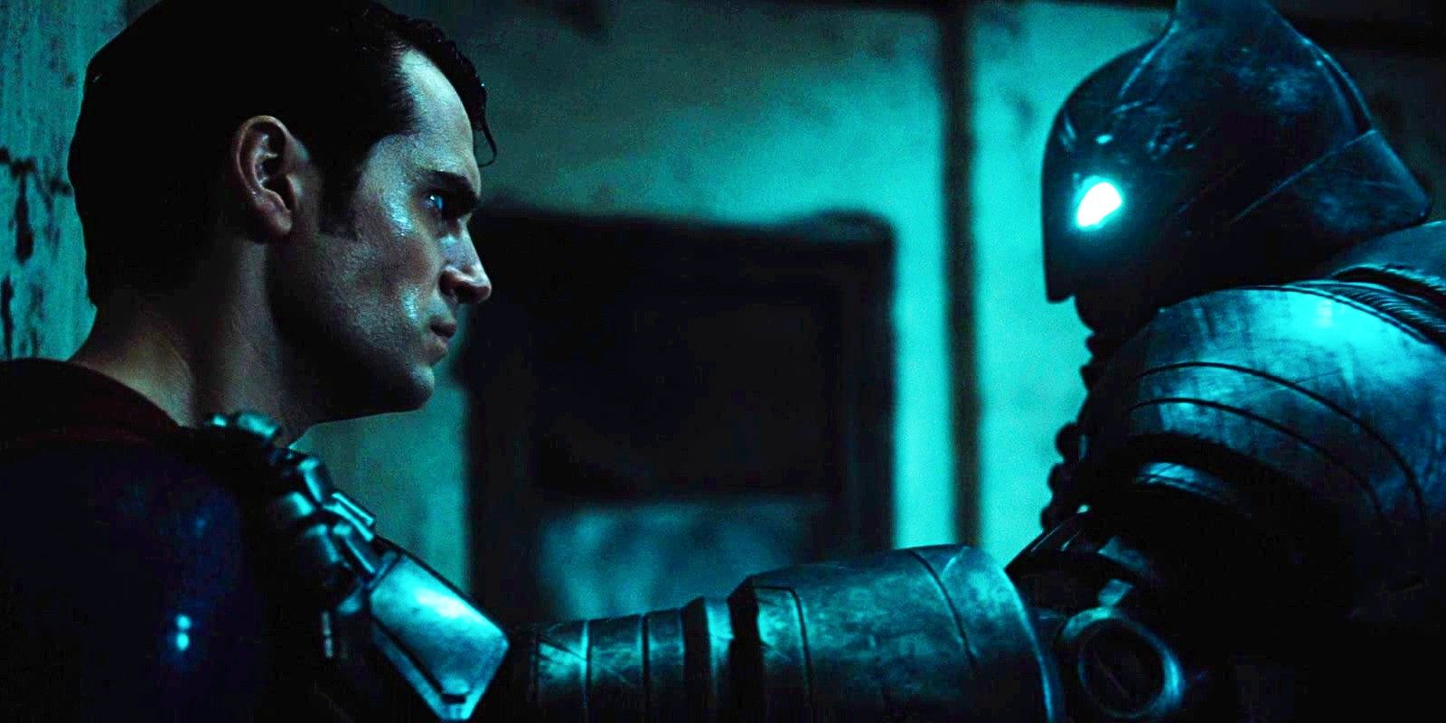 a sweaty Superman on a wall staring at Batman holding him, in Batman v Superman Dawn of Justice