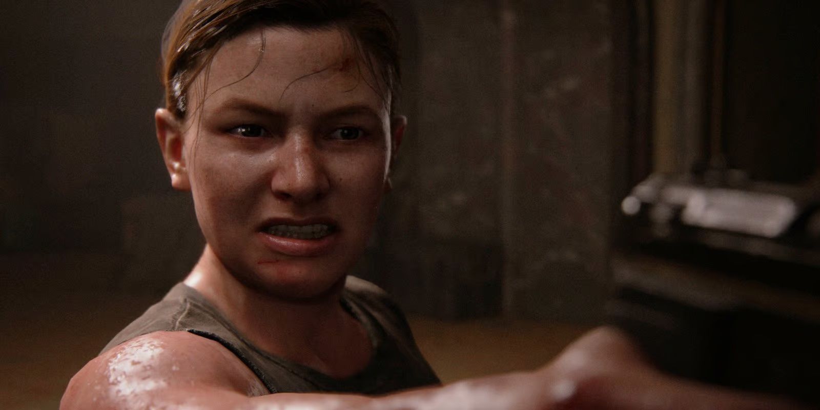 Abby segurando uma arma no cinema em The Last of Us Part II