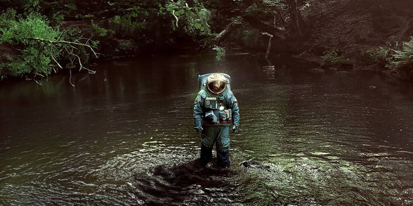 Adam Sandler standing alone in a river in Spaceman 2024