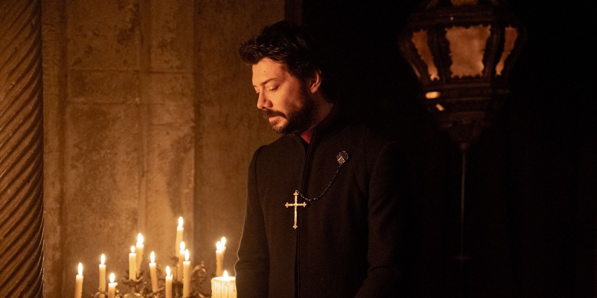 Alvaro Morte as Father Tedeschi in a candle-lit room in Immaculate