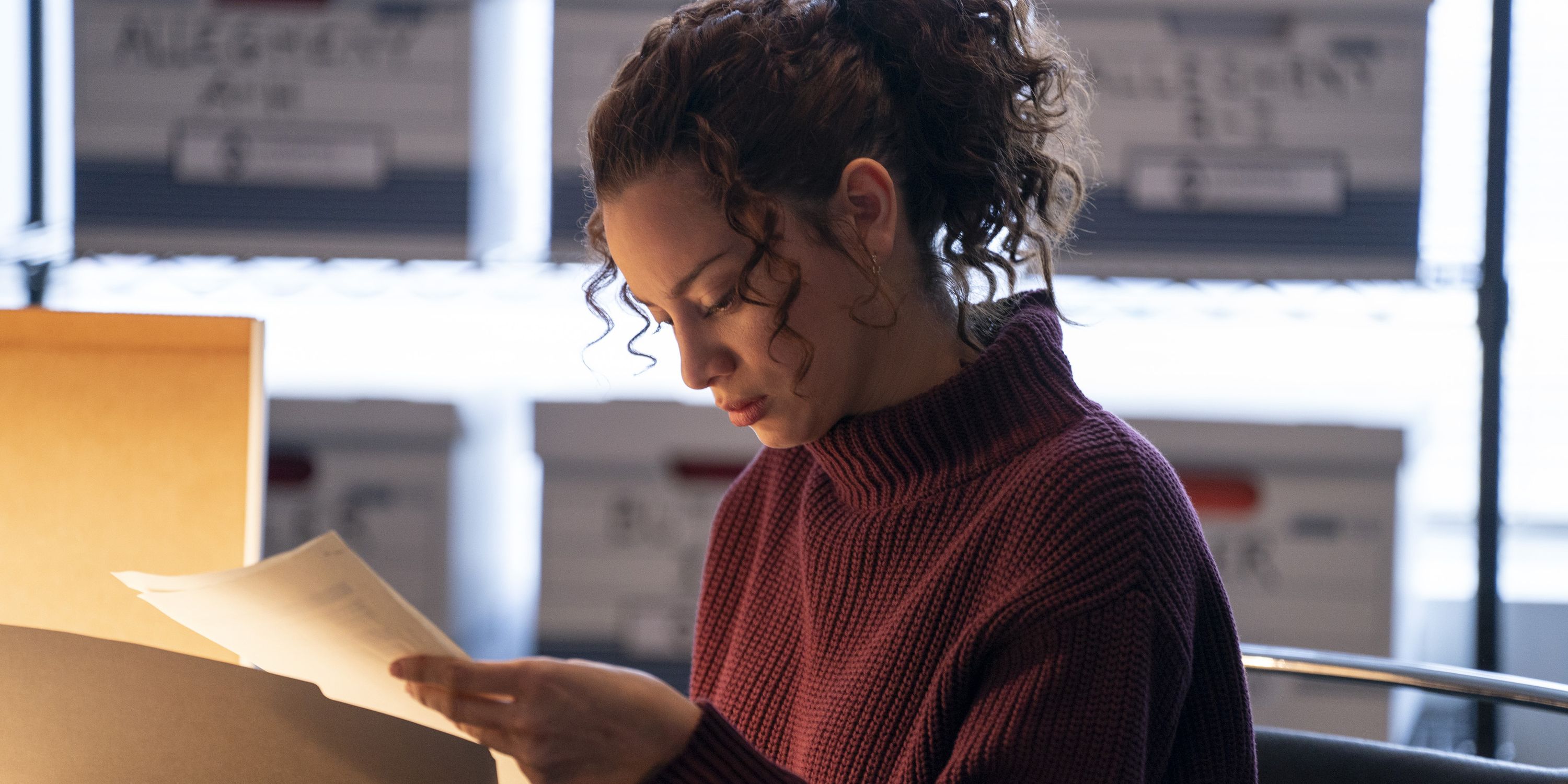 Lee looking at a document in American Rust season 2.