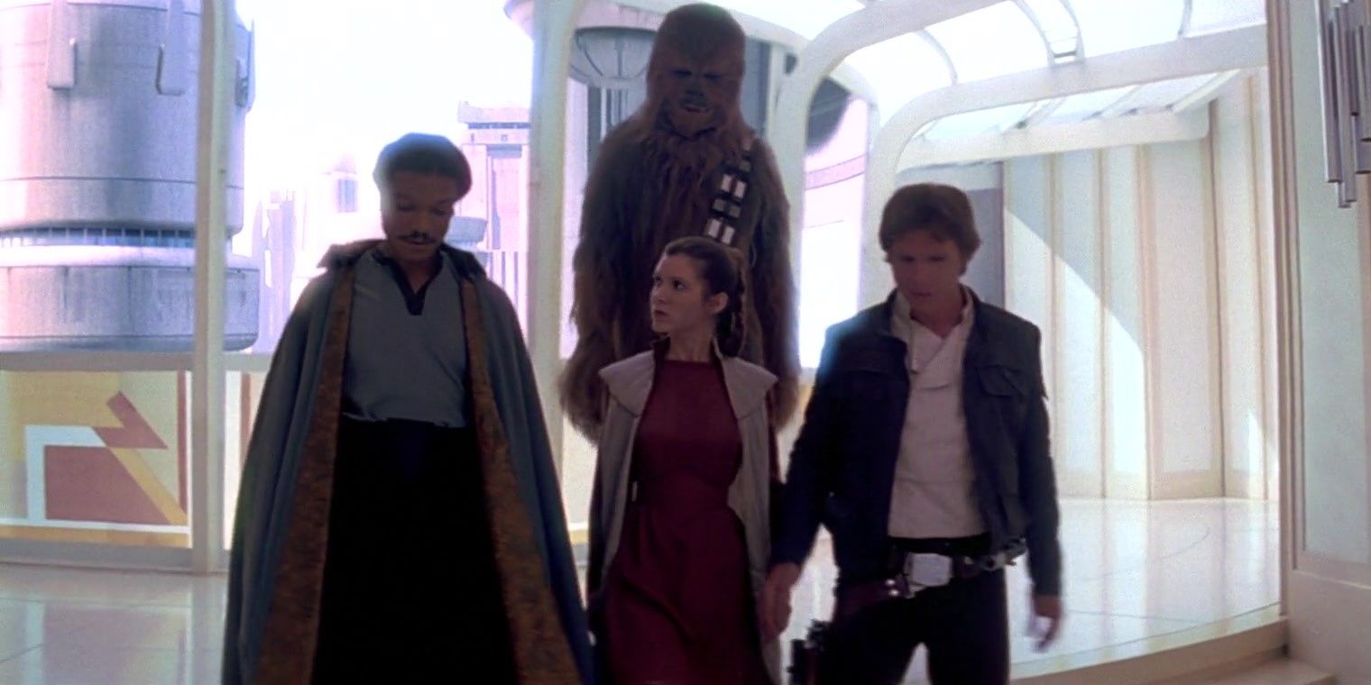 Lando Calrissian, Chewbacca, Leia Organa in her red robe, and Han Solo walk through a hallway in Cloud City on Bespin in The Empire Strikes Back