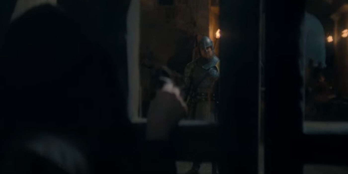 Blood and Cheese looking through a gate in King's Landing in House of the Dragon Season 2