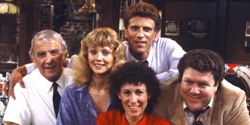 Cast of Cheers in a promotional image with Sam, Diane, Coach. Carla, and Norm
