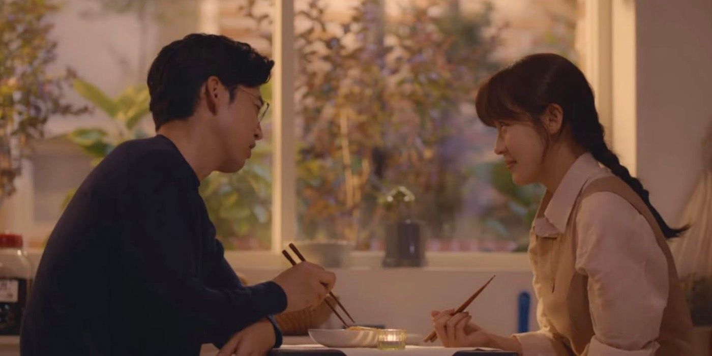 Lee Kang and Moon Cha-yeong are sitting down at a table and eating in the k-drama Chocolate