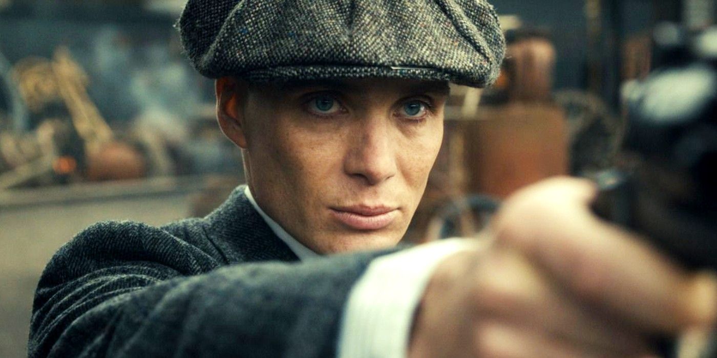 Cillian Murphy as Tommy Shelby holding a gun in Peaky Blinders