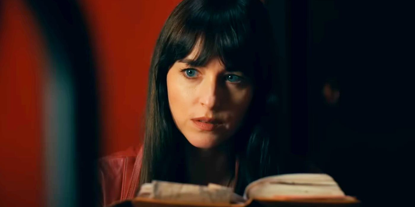 Dakota Johnson as Cassandra Web Looking Surprised While Reading a Book in Madame Web
