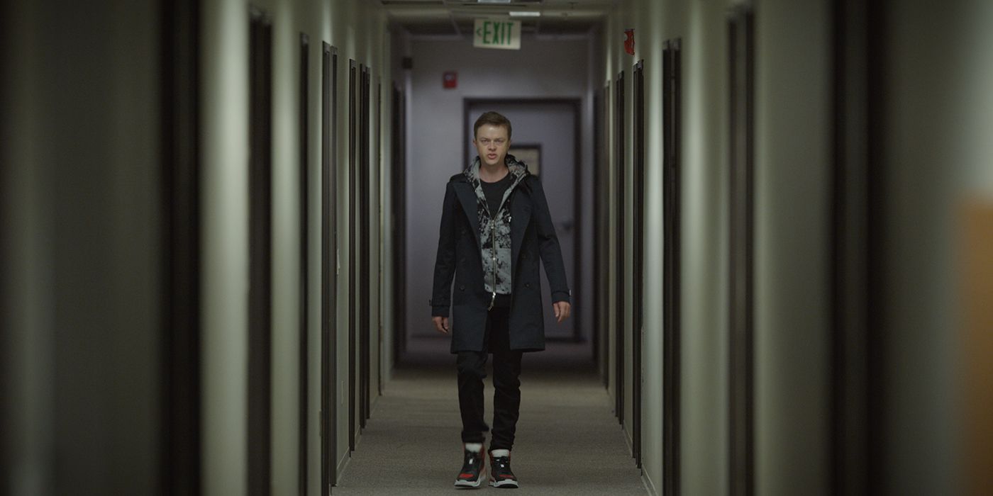 Dane DeHaan as Carl E walking menacingly down a hallway in The Stranger