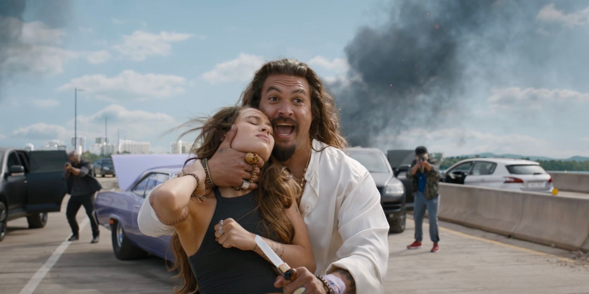 Dante (Jason Momoa) holds up a knife while choking Isabel (Daniela Melchior) in Fast X.