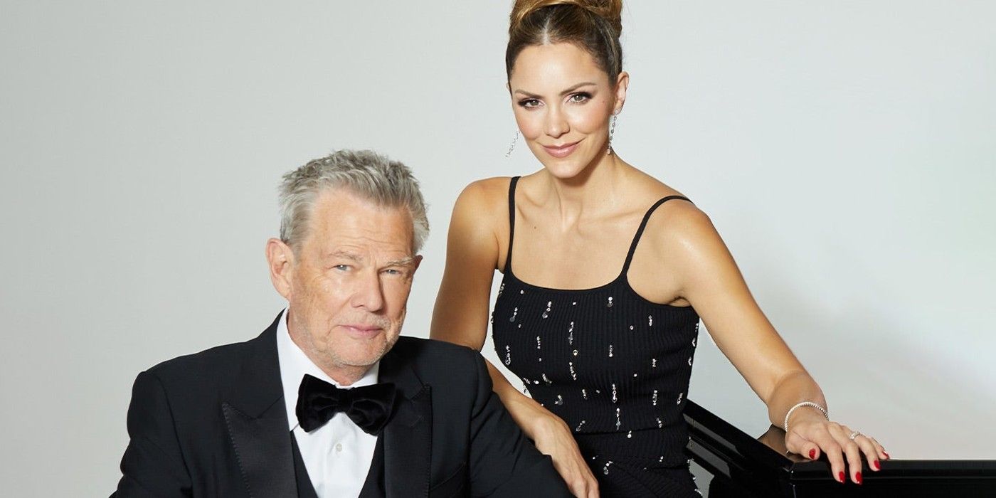 David Foster in black tuxedo and Katharine McPhee in black dress with sequins Posing Together