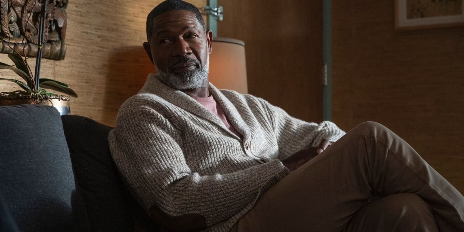 Dennis Haysbert in a sweater and slacks as God while he sits in a therpy session in Lucifer
