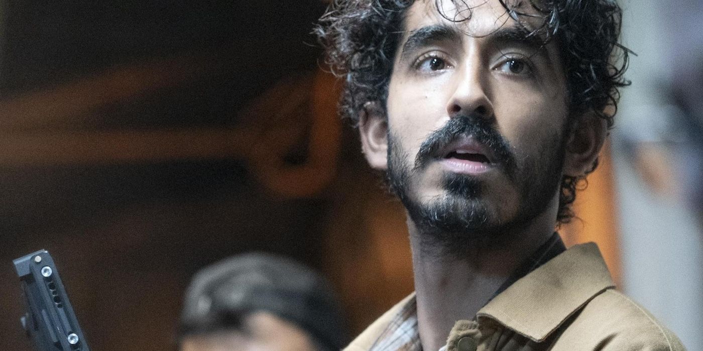 Dev Patel holds a camera while directing on the set of Monkey Man