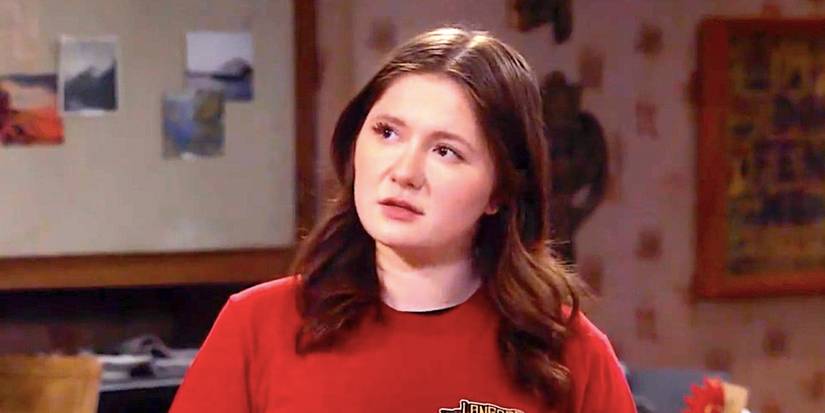 Emma Kenney's Harris talks to someone offscreen in a kitchen in The Conners season 6 episode 6