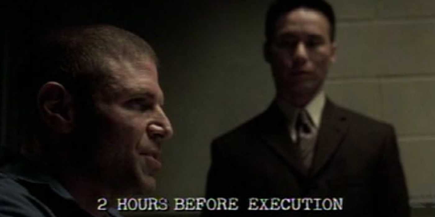 A prisoner talks while Wong observes him with a "2 hours before execution" timestamp over him in the SVU episode Execution